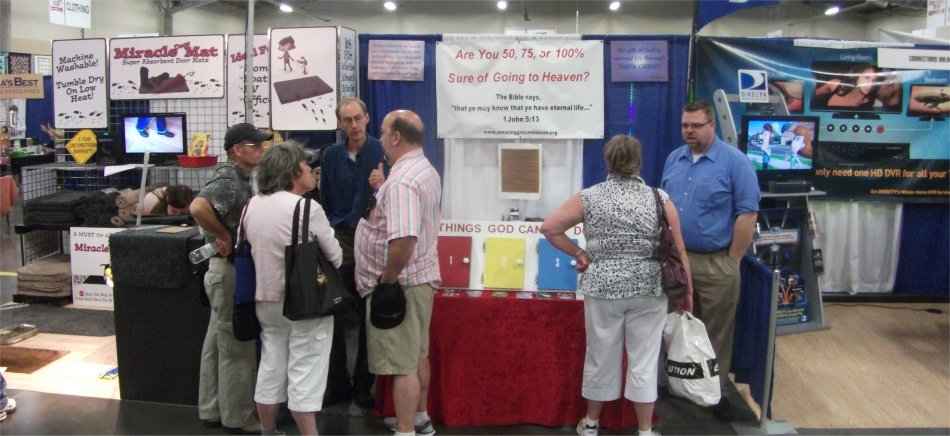 A conversation at an evangelism booth in the fair